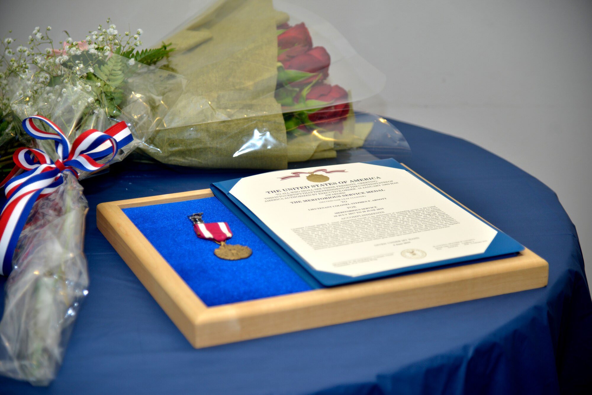 The Meritorious Service Medal is displayed at 81st Training Support Squadron change of command ceremony inside the Roberts Consolidated Aircraft Maintenance Facility on Keesler Air Force Base, Mississippi, June 20, 2019. Lt. Col. Elbert G. Mose, incoming 81st TRSS commander, assumed command from Lt. Col. Stephen Arnott with the passing of the guidon. The passing of the guidon is a ceremonial symbol of exchanging command from one commander to another. (U.S. Air Force photo by Airman Seth Haddix)