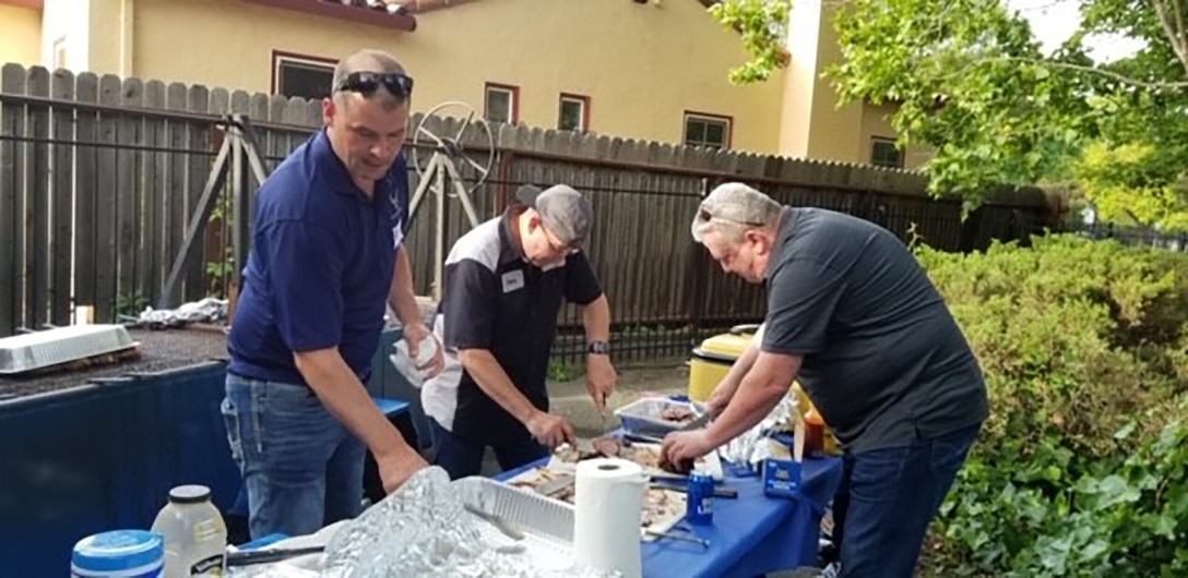 Team Travis Chiefs prepare the food for the NCO Appreciation Night.