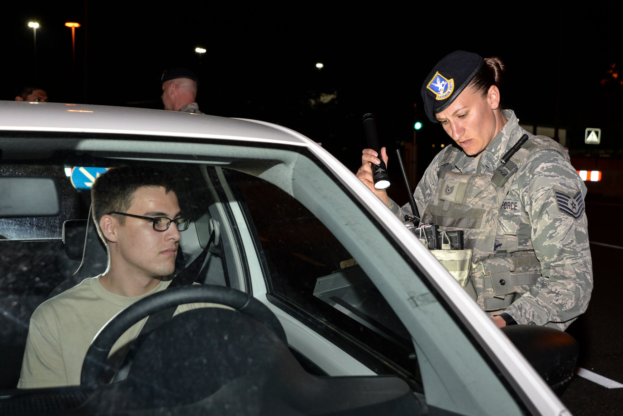 Airman conducts a night time random vehicle search on Ramstein Air Base, Germany.