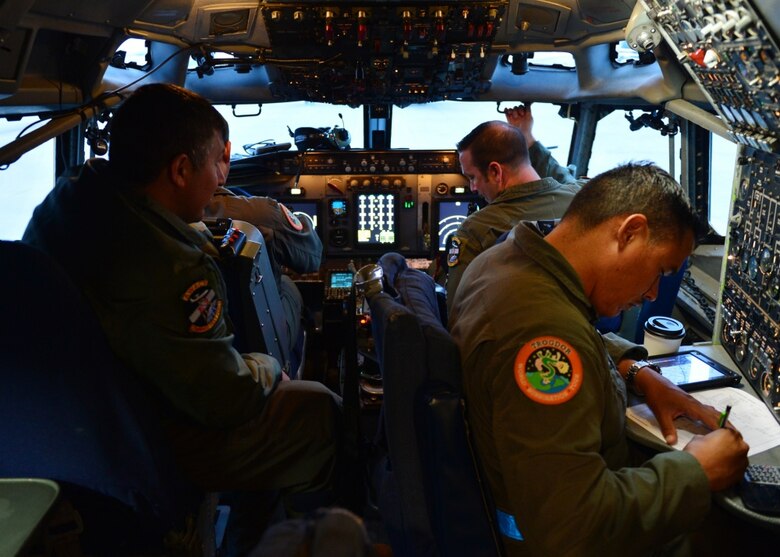 Pilots and flight engineers finalize the preflight check for an E-3 Airborne Warning and Control System at Ramstein Air Base, Germany, June 6. The AWACS aircraft is assigned to the 605th Test and Evaluation Squadron at Tinker Air Force Base, and was staged at Ramstein in support of Exercise Astral Knight. (U.S. Air Force photo/Staff Sgt. Jimmie D. Pike)