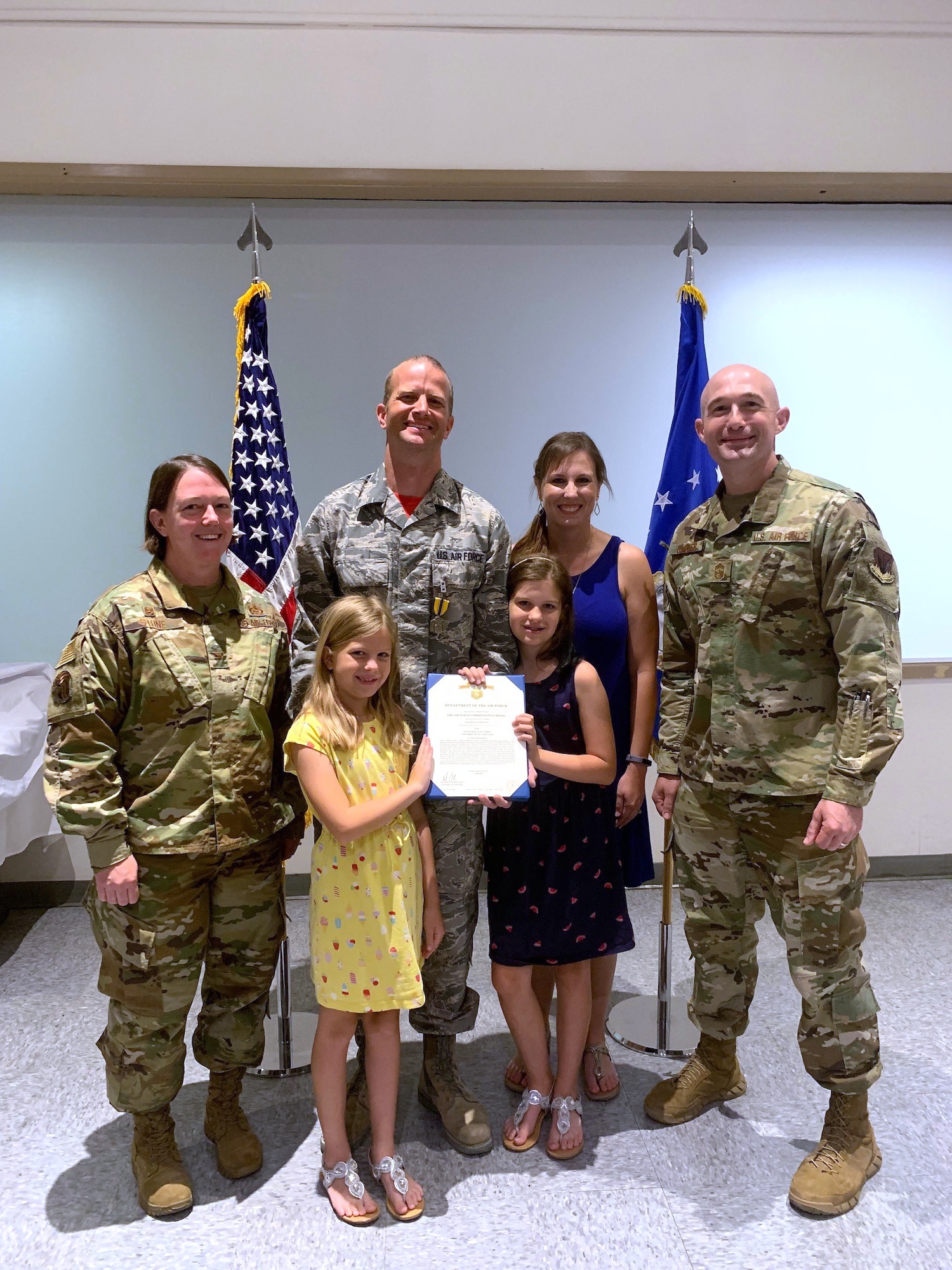 U.S. Air Force Col. Melissa Stone (far left), 363d ISR Wing commander, and Chief Master Sgt. Stefan Blazier (far right), 363d ISRW command chief, present Master Sgt. Zachary H. (center), 547th IS operations superintendent, with the Air Force Commendation Medal at Nellis Air Force Base, Nevada, June 14, 2019. Zachary led the renovation and modernization efforts to bring the U.S. Air Force’s only threat training facility to meet the needs of today’s warfighters from Nov. 1, 2018 to March 1, 2019.