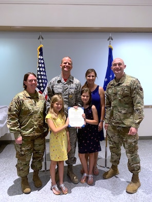 U.S. Air Force Col. Melissa Stone (far left), 363d ISR Wing commander, and Chief Master Sgt. Stefan Blazier (far right), 363d ISRW command chief, present Master Sgt. Zachary H. (center), 547th IS operations superintendent, with the Air Force Commendation Medal at Nellis Air Force Base, Nevada, June 14, 2019. Zachary led the renovation and modernization efforts to bring the U.S. Air Force’s only threat training facility to meet the needs of today’s warfighters from Nov. 1, 2018 to March 1, 2019.