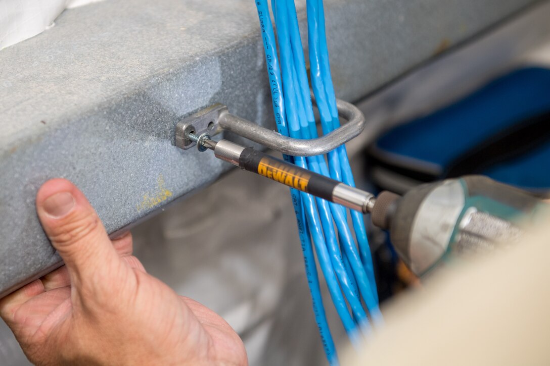 U.S. Air Force Master Sgt. Wesley Haines, 178th Communications Squadron infrastructure operations chief from the Ohio Air National Guard, drills a D-ring to an I-Beam at Tyndall Air Force Base, Florida, June 18, 2019.