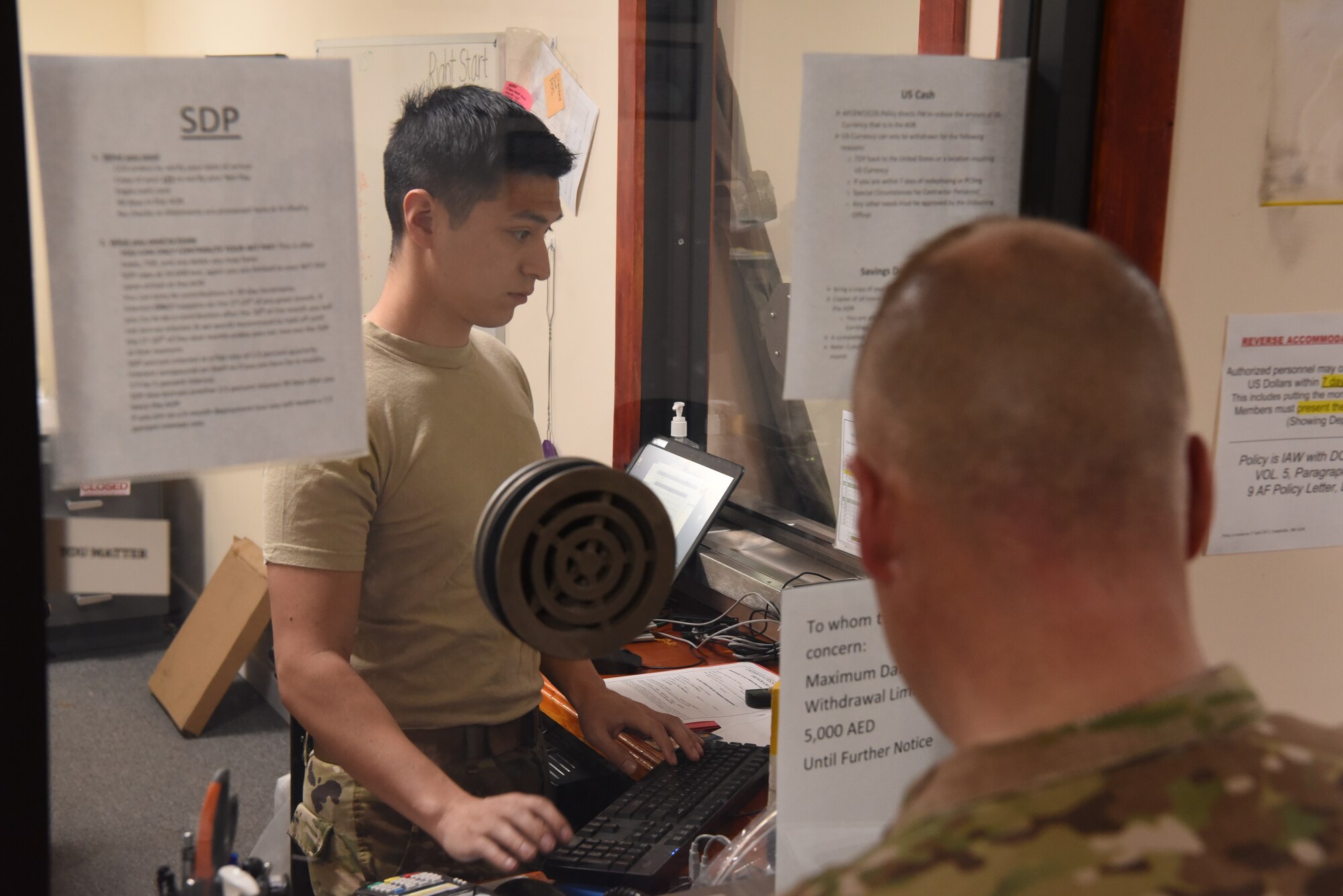 Senior Airman David Gonzalez works inside the cashier’s cage of the 380th Air Expeditionary Wing finance office June 6, 2019, at Al Dhafra Air Base, United Arab Emirates.