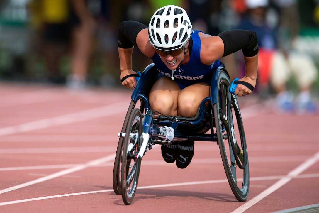 A veteran in a wheelchair races on a track.