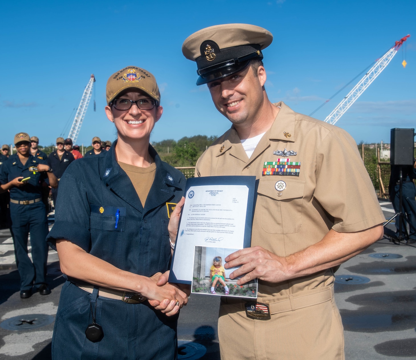 Senior Chief Quartermaster Kevin Oliver, left, takes a picture with Cmdr. Janice Pollard, commanding officer the USS Harpers Ferry (LSD 49) after he was frocked to Senior Chief Petty Officer aboard the ship.  Harpers Ferry is part of the Boxer Amphibious Ready Group (ARG) and 11th Marine Expeditionary Unit (MEU) team and is deployed to the U.S. 7th Fleet area of operations to support regional stability, reassure partners and allies, and maintain a presence postured to respond to any crisis ranging from humanitarian assistance to contingency operations.