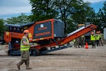 U.S. Army Staff Sgt. Donald Day, Defense Logistics Agency Joint Reserve Force material supply noncommissioned officer, guides a shredder into position to destroy office chairs during the Overseas Contingency Operations Readiness Training exercise in Battle Creek, Mich., June 14, 2019.OCORT prepares military and civilian agency personnel for constructing and manning portable disposal sites that can be shipped and used nearly anywhere in the world. (U.S. Air Force photo/Tech Sgt. Zachary Wolf)