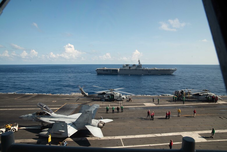 190619-N-JK118-1059 SOUTH CHINA SEA (June 19, 2019) Japan Maritime Self-Defense Force (JMSDF) ship JS Izumo (DH-183) sails alongside the Navy’s forward-deployed aircraft carrier USS Ronald Reagan (CVN 76) during Reagan’s flight operations. Ronald Reagan, the flagship of Carrier Strike Group 5, provides a combat-ready force that protects and defends the collective maritime interests of its allies and partners in the Indo-Pacific region.
