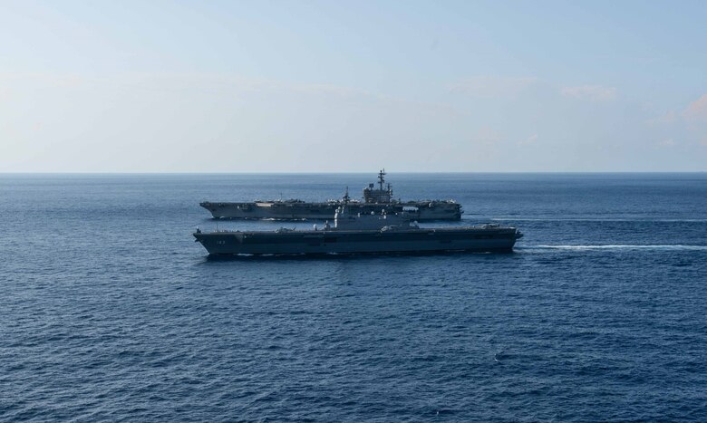 SOUTH CHINA SEA (June 19, 2019) The U.S. Navy’s forward-deployed aircraft carrier USS Ronald Reagan (CVN 76) sails alongside the Japan Maritime Self Defense Force helicopter destroyer JS Izumo (DDH 183) while conducting operations in the South China Sea. Ronald Reagan, the flagship of Carrier Strike Group 5, provides a combat-ready force that protects and defends the collective maritime interests of its allies and partners in the Indo-Pacific region.