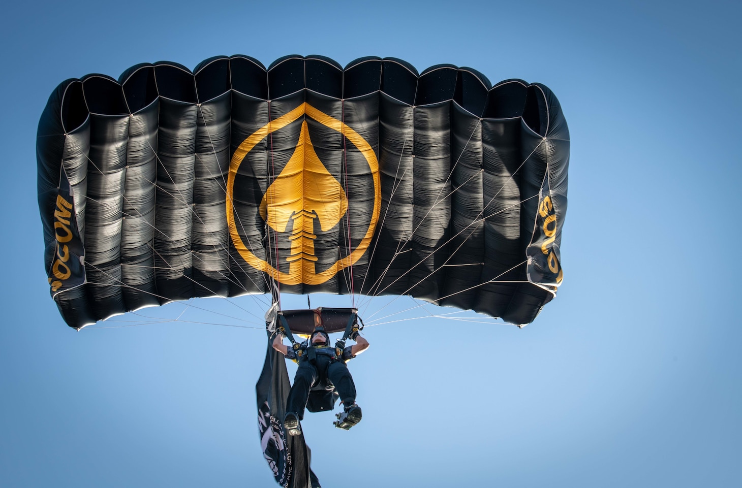 A member of the U.S. Special Operations Command parachute team lands from above at the 2019 DoD Warrior Games cycling time trials in Tampa, Florida.