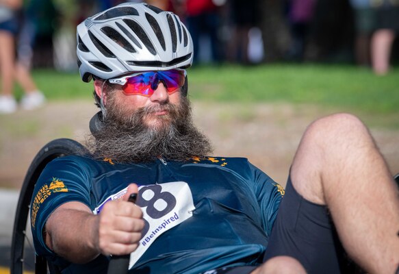 A male athlete apart of Team Navy, rides a bike during the cycling time trials for the 2019 DoD Warrior Games in Tampa, Florida.