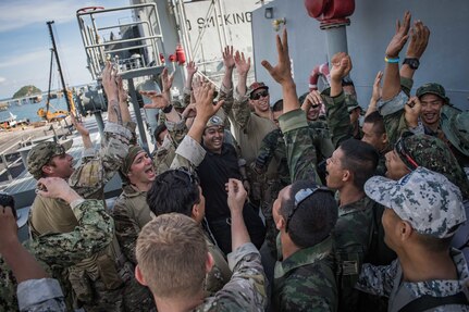 Royal Thai Navy and U.S. Coast Guardsmen celebrate after a visit, board, search, and seizure (VBSS) drill aboard the Quiandaohu-class auxiliary ship HTMS Similan (AOR 871) as part of Cooperation Afloat Readiness and Training (CARAT) Thailand 2019. (U.S. Navy photo by Mass Communication Specialist 2nd Class Joshua Mortensen)