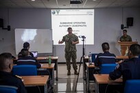 Capt. Andrew Ring, director of submarine operations for Commander, Submarine Force, U.S. Pacific Fleet (COMSUBPAC), speaks with officers from the Royal Thai Navy Submarine Command about submarine operations during a subject-matter-expert exchange for Cooperation Afloat Readiness and Training (CARAT) Thailand 2019. (U.S. Navy photo by Mass Communication Specialist 2nd Class Joshua Mortensen)