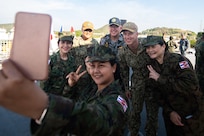 Members of the Royal Thai Armed Forces pose for a selfie with U.S. Navy Capt. Randy Van Rossum, Pacific Partnership 2019 (PP19) mission commander, Royal Australian Navy Capt. Brendon Zilko, PP19 chief of staff, and U.S. Navy Cdr. Edgar San Luis during the PP19 opening ceremony for Thailand. (U.S. Navy photo by Mass Communication Specialist 2nd Class Nicholas Burgains)