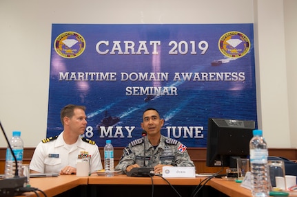 U.S. Navy Lt. Cmdr. Todd Hutchins, staff judge advocate assigned to Commander, Logistics Group Western Pacific, and Royal Thai Navy Capt. Yuthanavi Mungthanya, commanding officer of HTMS Bandpakong (FFG 456), participate in a maritime domain awareness seminar during Cooperation Afloat Readiness and Training (CARAT) Thailand 2019. (U.S. Navy photo by Mass Communications Specialist 2nd Class Corbin Shea)