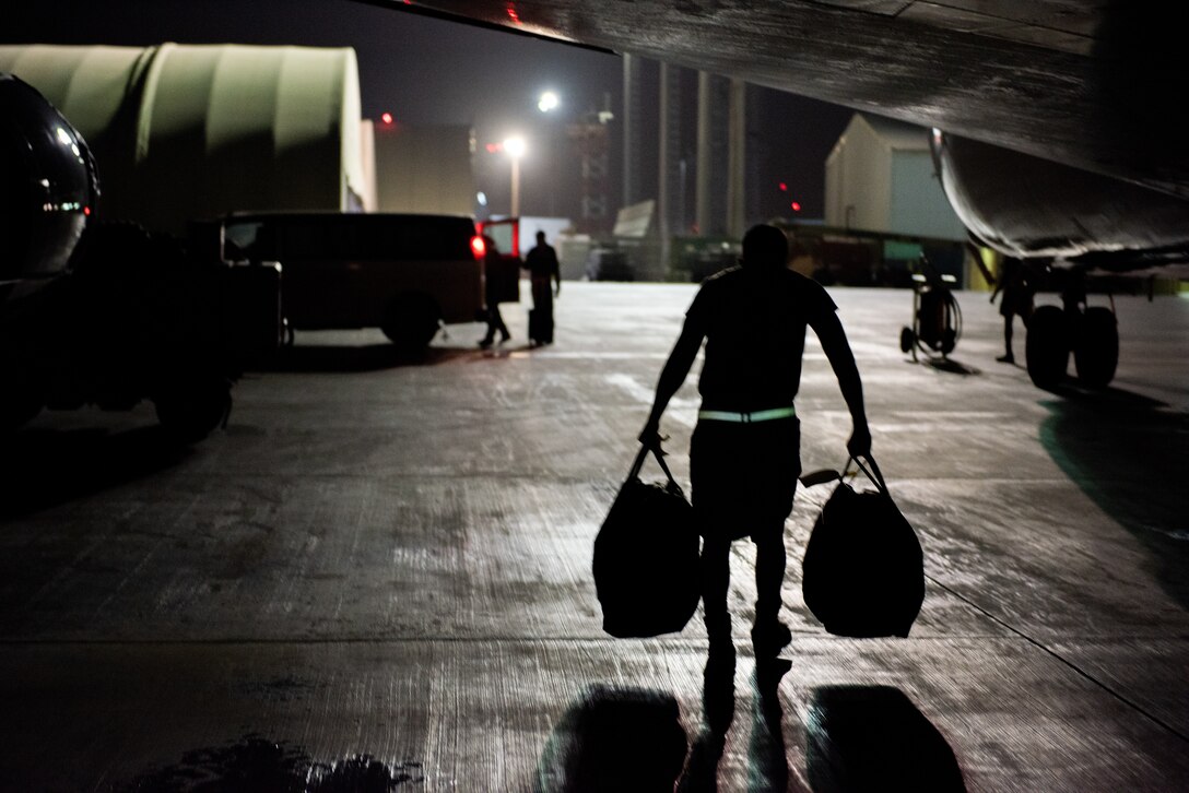 Tech. Sgt. Walter Bolles, 380th Expeditionary Operations Support Squadron E-3 Sentry aircrew flight equipment technician, carries life preservation vests June 19, 2019, at Al Dhafra Air Base, United Arab Emirates.