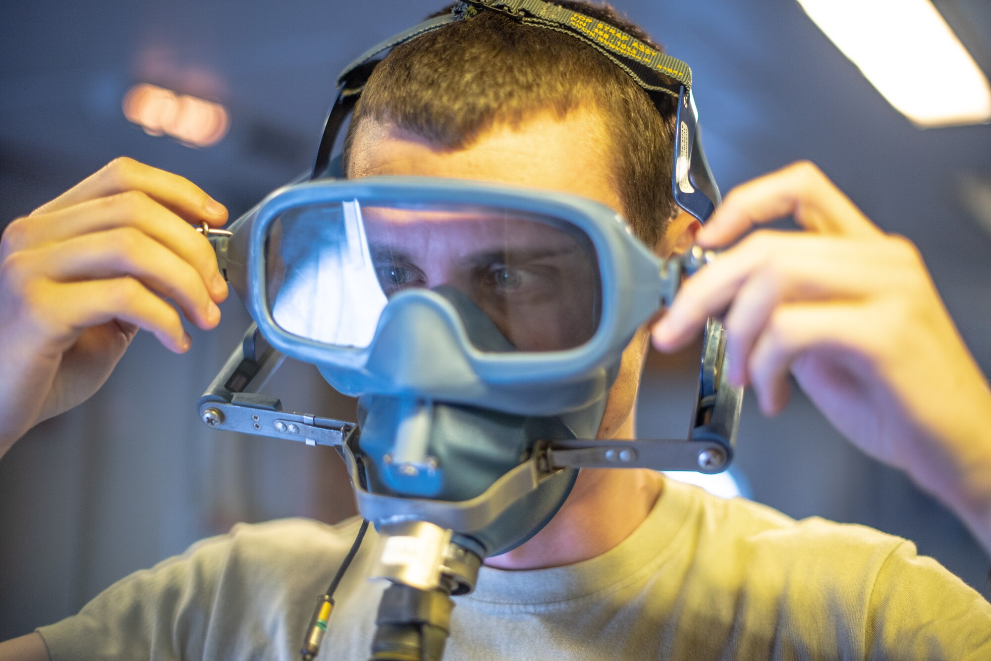 Airman 1st Class Ryan Bayles, 908th Expeditionary Refueling Squadron boom operator, tests an oxygen mask June 19, 2019, at Al Dhafra Air Base, United Arab Emirates.