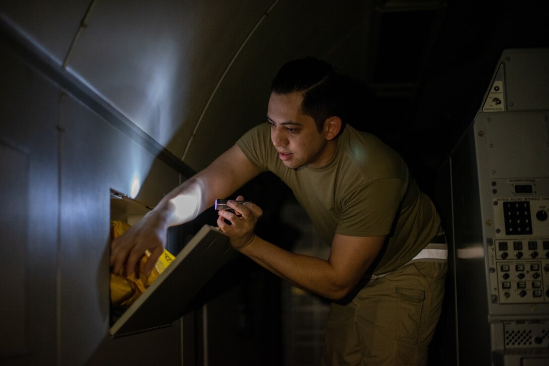 Tech. Sgt. Walter Bolles, 380th Expeditionary Operations Support Squadron E-3 Sentry aircrew flight equipment technician, replaces old life preservation units with new and better designed units June 19, 2019, at Al Dhafra Air Base, United Arab Emirates.