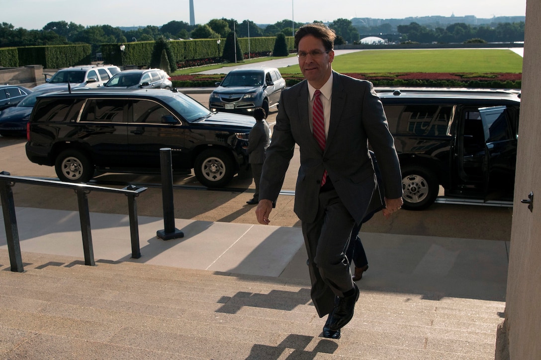 A man walks up the steps of the Pentagon.