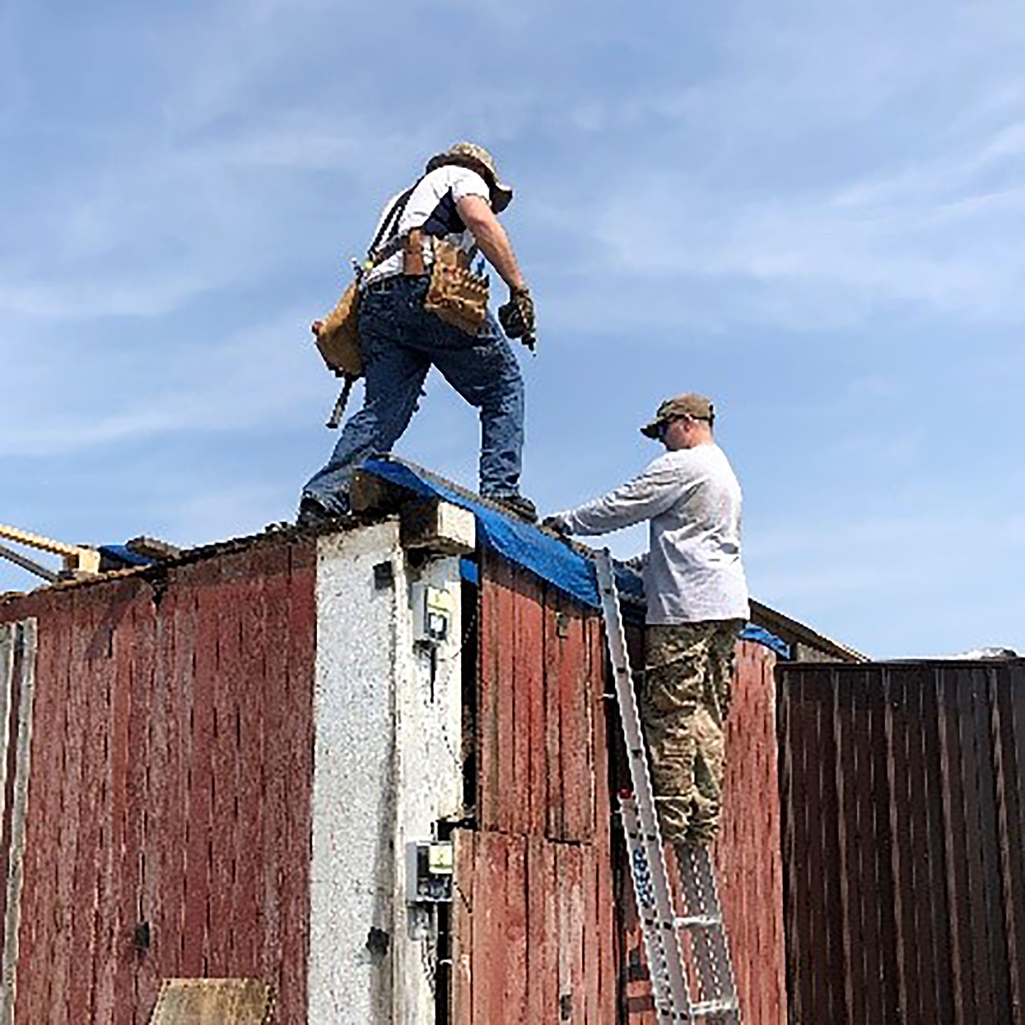 655th Intelligence, Surveillance, and Reconnaissance Wing, 71st Intelligence Squadron, Director of Operations Maj. Miller (first name withheld) and another volunteer repair a structure at a Dayton area farm June 1, 2019. Several tornados caused several injuries and severe property damage earlier in the week.