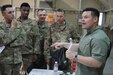 Army Maj. Kristjan Rauhala, right, adjutant, U.S. Army Central (Forward), discusses the importance of firearms safety with attendees at the ARCENT Safety Fair at Camp Arifjan, Kuwait, June 21, 2019. The safety fair is a highlight of the U.S. Army Central’s 101 Critical Days of Summer safety program that encourages leaders to engage with their Soldiers and to stress the importance of being safe in everything they do.
