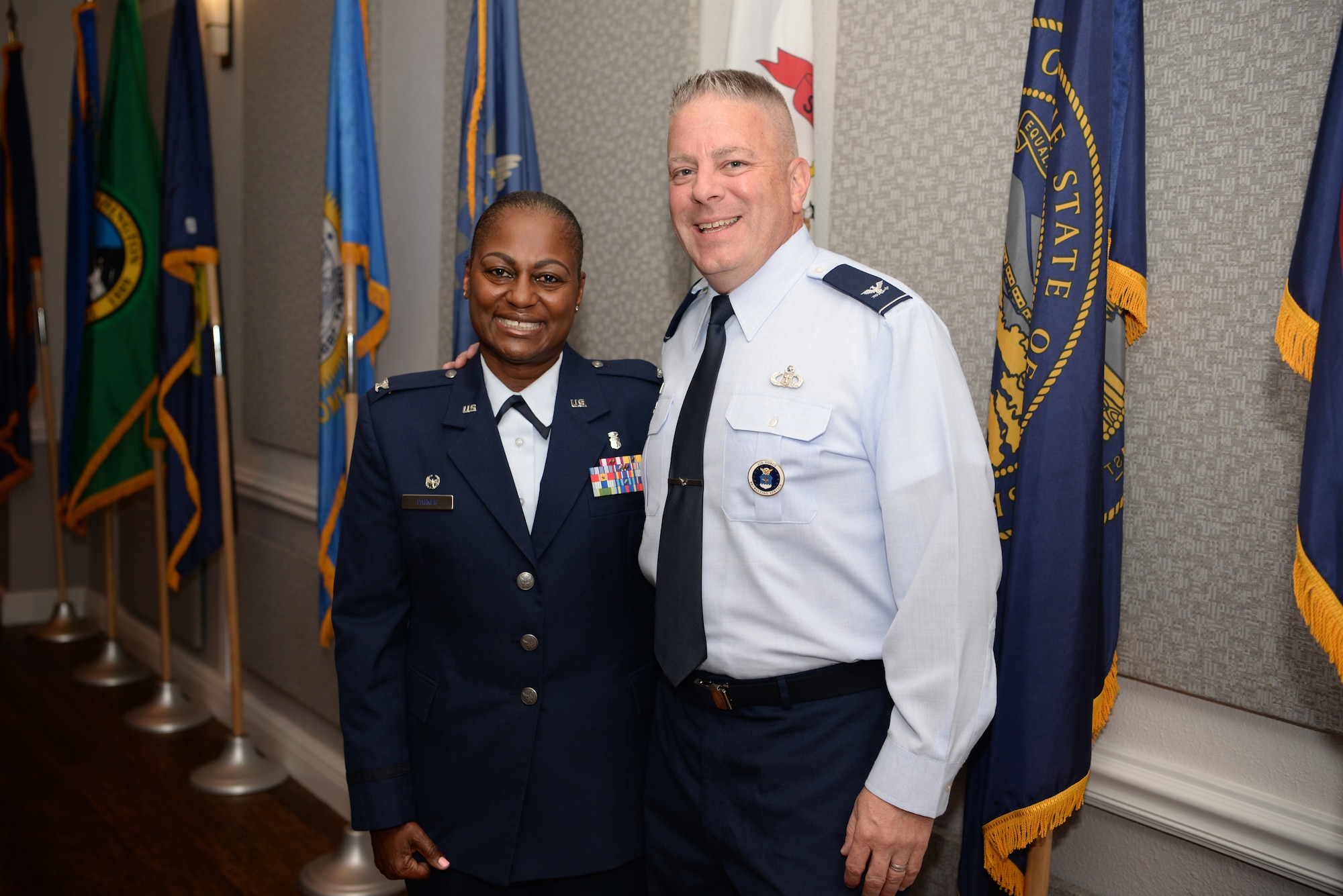 U.S. Air Force Col. Mary Parker, incoming 81st Inpatient Operations Squadron commander, and Retired Col. Robert Trayer, Parker's husband, pose for a photo inside the Don Wylie Auditorium on Keesler Air Force Base, Mississippi, June 21, 2019.