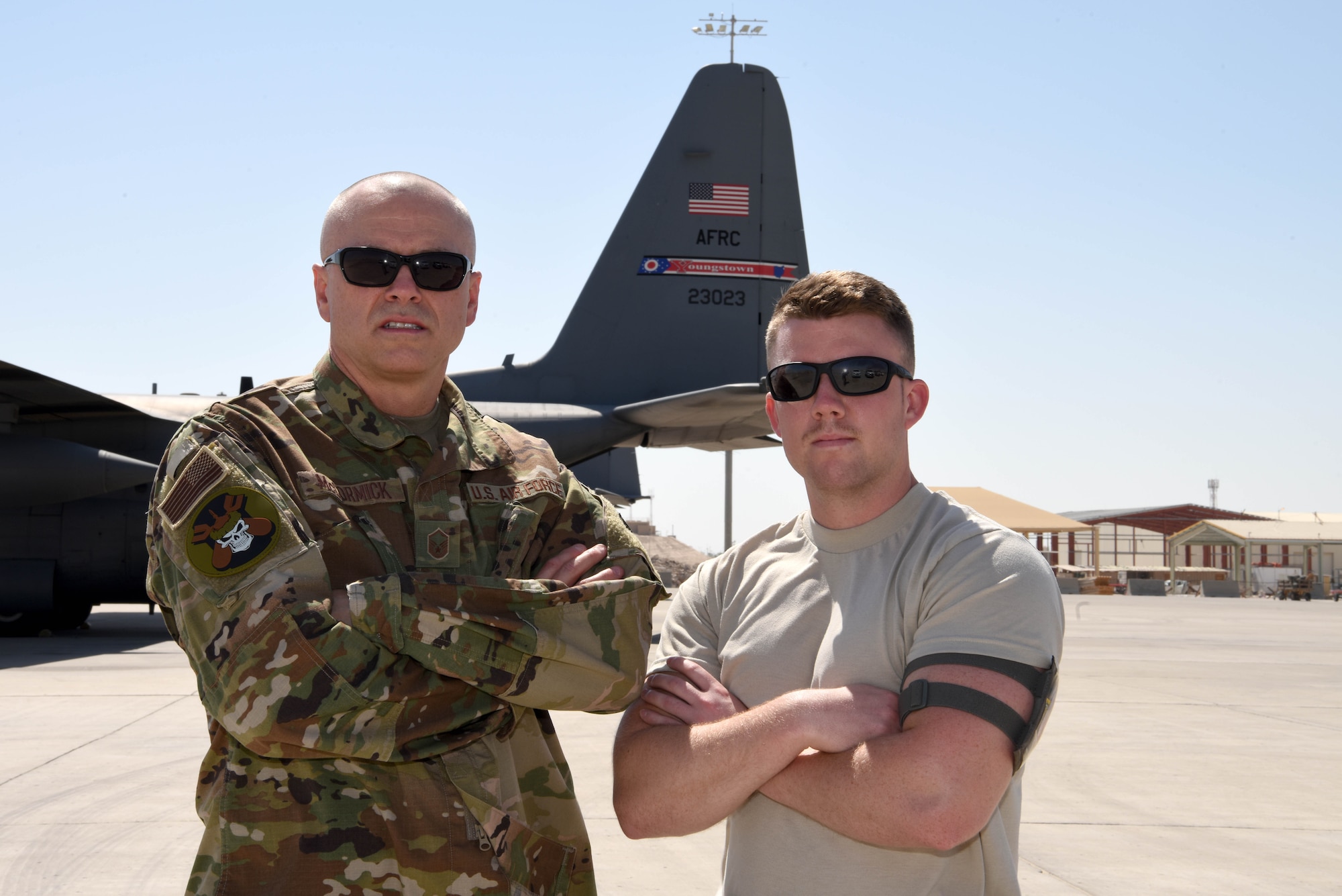 Mgt. Donald McCormick, 379th Expeditionary Operation Support Squadron C-130 aircrew flight equipment section NCOIC and Staff Sgt. Dillon McCormick, 379th Expeditionary Aircraft Maintenance Squadron aircraft electrician take a photo together at Al Udeid Air Base, Qatar on June 21, 2019. For the father and son duo, the experience of serving together has been very positive especially while being deployed. (U.S. Air Force photo by Staff Sgt. Ashley L. Gardner)