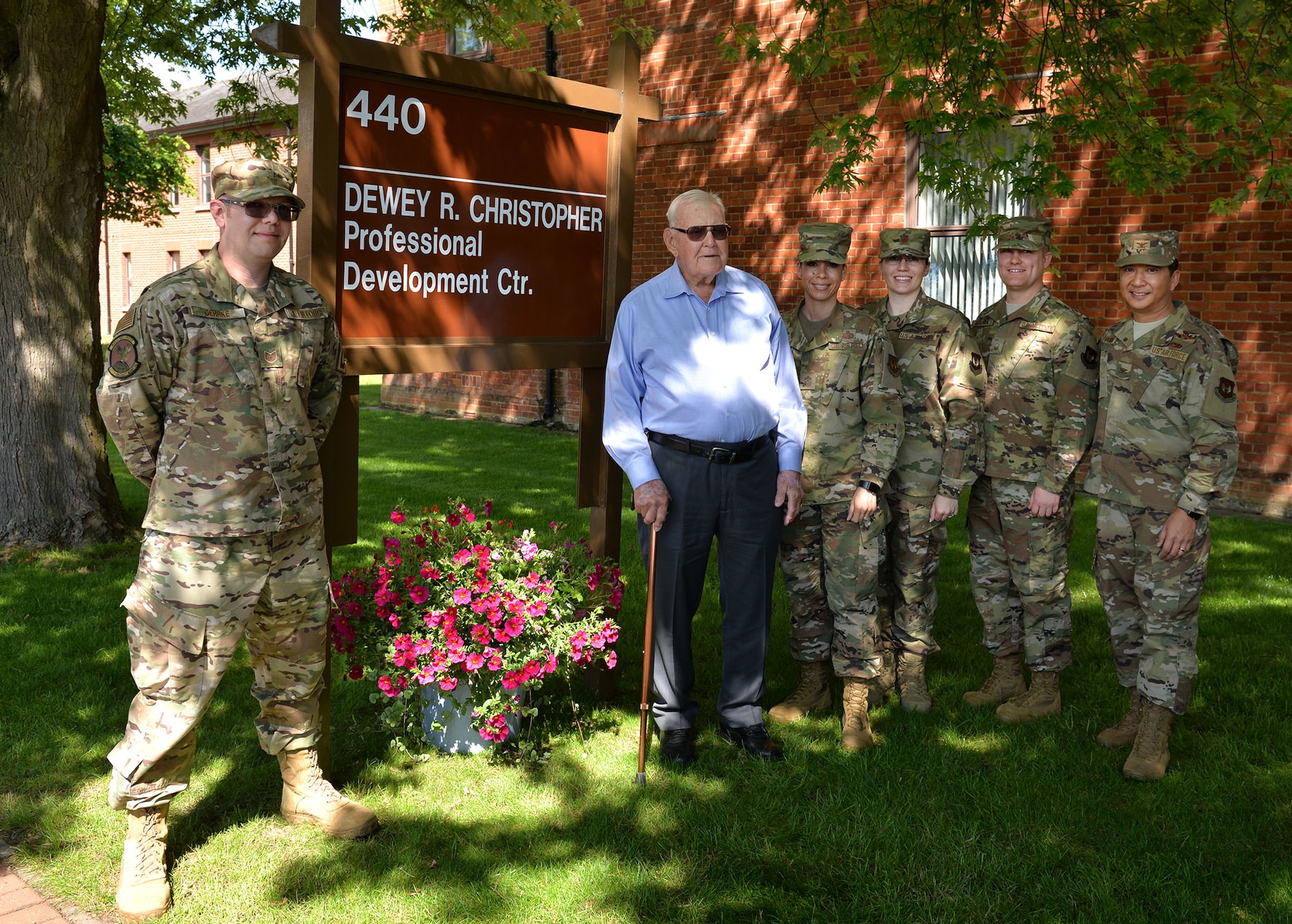 Retired Master Sgt. Dewey Christopher, second left, a former 351st Bomb Squadron crew chief, 100th Bomb Group and World War II veteran, poses for a photo with 100th Air Refueling Wing leadership at the Professional Development Center renaming ceremony on RAF Mildenhall, June 21, 2019. The PDC was renamed the “Dewey R. Christopher Professional Development Center” to honor his legacy and enhance heritage for enlisted members. (U.S. Air Force photo by Karen Abeyasekere)