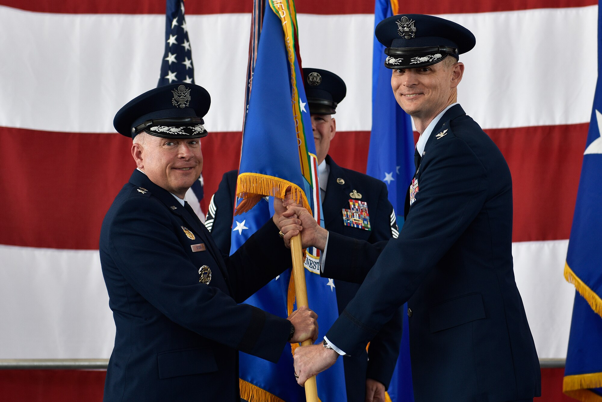Col. David Miller (right), incoming 377th Air Base Wing commander, receives the guidon and command of the 377th Air Base Wing from 20th Air Force Commander Maj. Gen. Ferdinand B. Stoss III in a ceremony June 21, 2019 at Kirtland Air Force Base. Stoss officiated the transfer of command from former commander Col. Richard Gibbs in a traditional change of command ceremony at Kirtland’s Hangar 333. Miller comes to Kirtland from Malmstrom AFB, Mont., where he was commander of the 341st Maintenance Group. Gibbs, selected for brigadier general, is on his way to Air Mobility Command and Scott AFB, Ill., where he will become the Director of Logistics, Engineering, and Force Protection (A4). (U.S. Air Force photo by Airman 1st Class Austin J. Prisbrey)