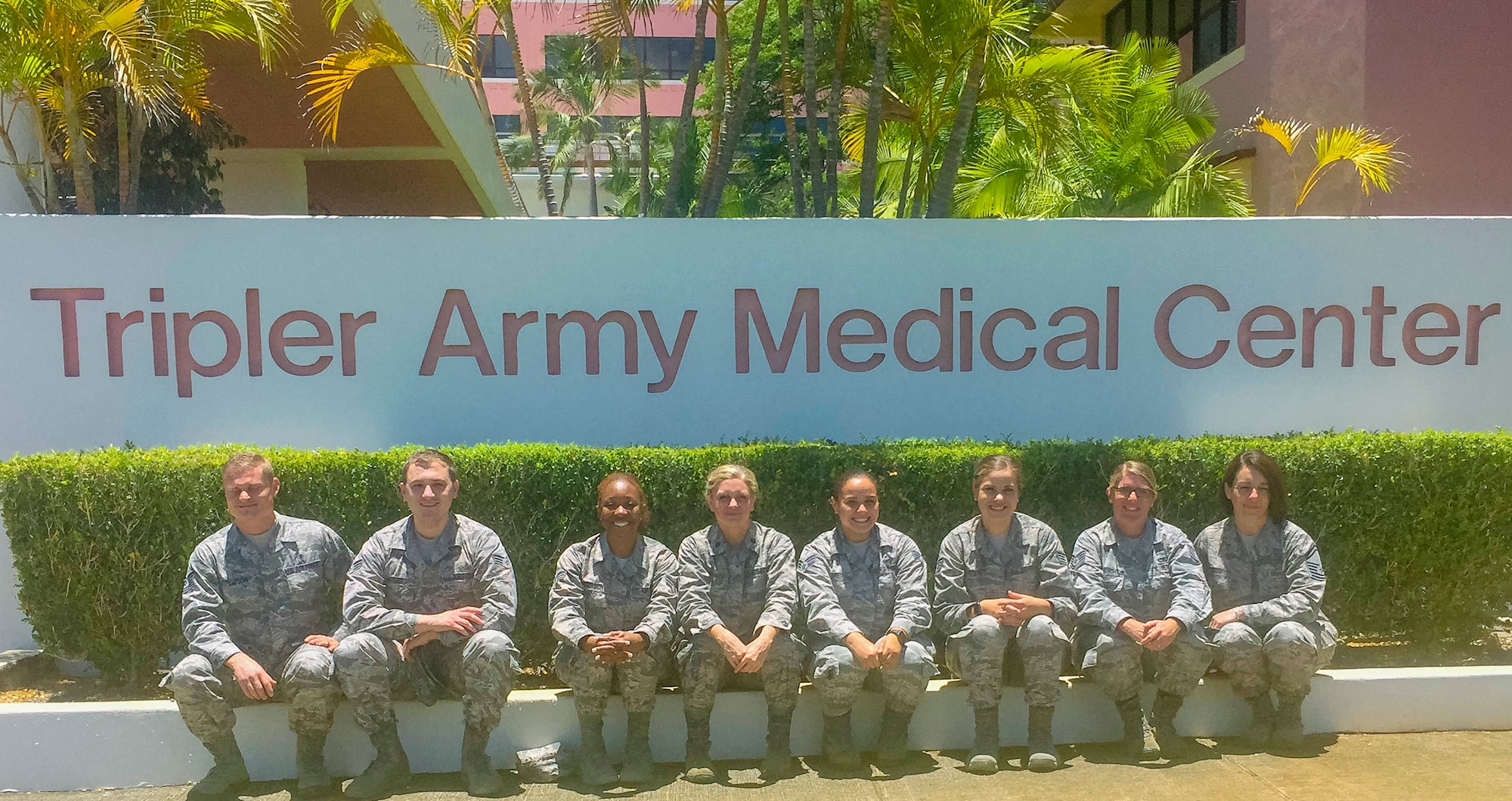 913th Aerospace Medicine Squadron members pose in front of the Tripler Army Medical Center sign to kick off their annual training on June 6, 2019 in Honolulu. As traditional reservists, members must maintain military readiness requirements while balancing fulltime civilian jobs or college studies. The group consists of Tech. Sgt. Eric Ferguson, Senior Airman Jonathan Hefley, Senior Airman Shanice Anderson, Lt. Col. Tee Jay McKenzie, Senior Airman Alexis Baker, Staff Sgt. Kristen Frandson, Tech. Sgt. Bridget Goodknight, and Senior Master Sgt. Valerie Inman. (Courtesy photo)