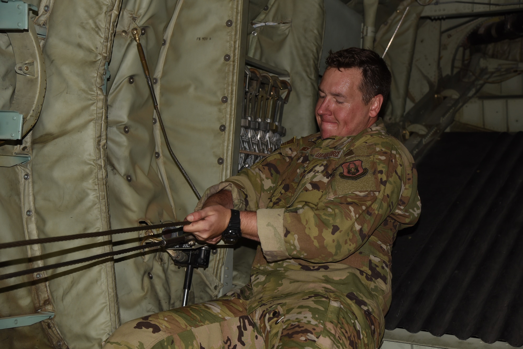 Tech. Sgt. Brandon Price, a loadmaster with the 815th Airlift Squadron, 403rd Wing, secures a static line cable in preparation for Army airborne units to use for their jump during exercise Swift Response 19, June 12, 2019. The exercise is one of the premier military crisis response training events featuring high readiness airborne forces from eight NATO nations. Activities include intermediate staging base operations, multiple airborne operations, and several air assault operations. The Swift Response exercises have had great success in creating a foundation for the strong relationships we share with several European allies and partners today. (U.S. Air Force photo by Master Sgt. Jessica Kendziorek)
