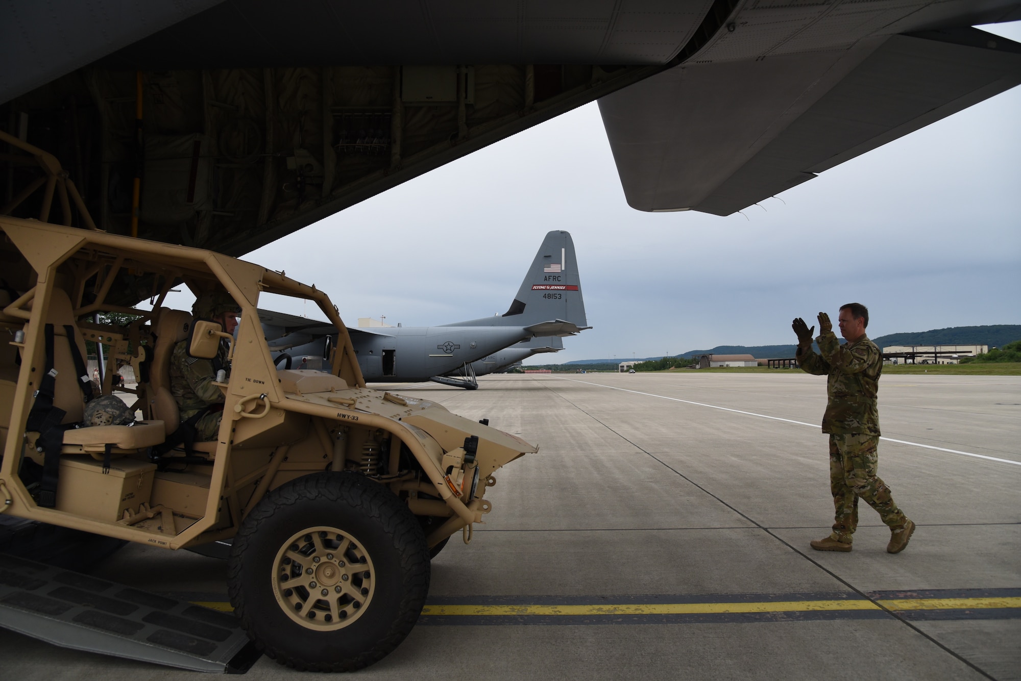 Senior Master Sgt. Dave Cooper, a loadmaster with the 815th Airlift Squadron, 403rd Wing, directs Corporal Jared Guden, 82nd Airborne, scout platoon team leader, as he drove a ground mobility vehicle, onto a C-130J in preparation for exercise Swift Response 19, June 14, 2019. The exercise is one of the premier military crisis response training events featuring high readiness airborne forces from eight NATO nations. Activities include intermediate staging base operations, multiple airborne operations, and several air assault operations. The Swift Response exercises have had great success in creating a foundation for the strong relationships we share with several European allies and partners today. (U.S. Air Force photo by Master Sgt. Jessica Kendziorek)