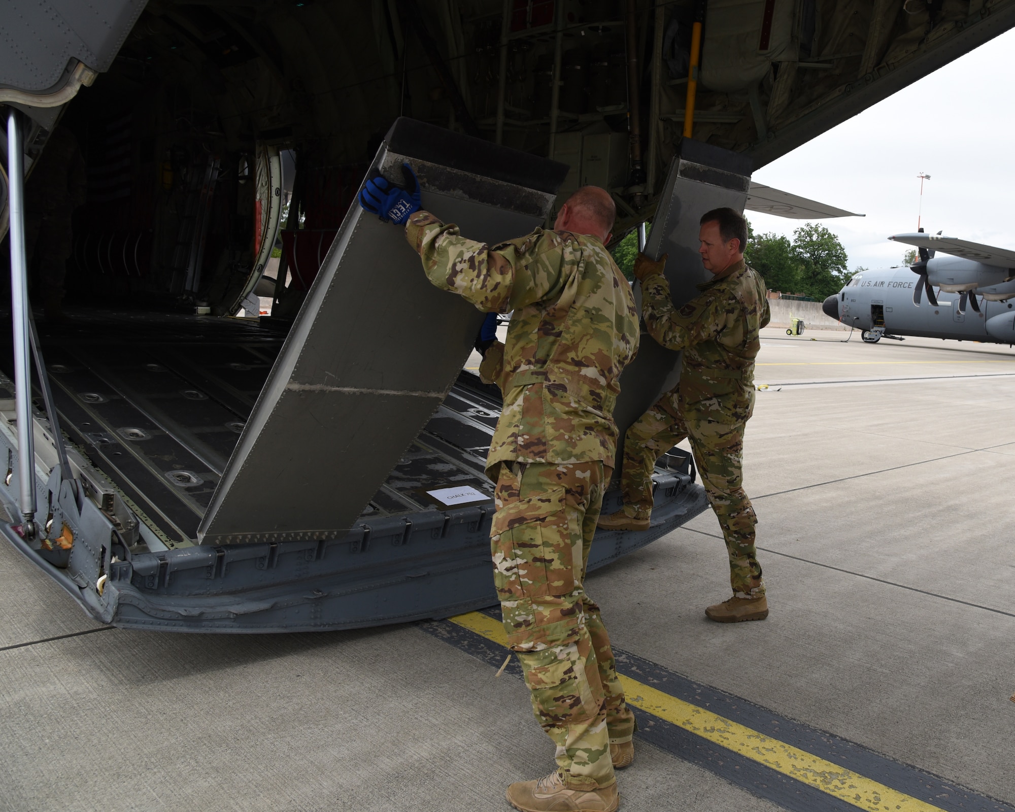 Senior Master Sgts. Dave Cooper and John Kittrell, loadmasters with the 815th Airlift Squadron, 403rd Wing, move ramps of the cargo section to load ground mobility vehicles for exercise Swift Response 19, June 14, 2019. The exercise is one of the premier military crisis response training events featuring high readiness airborne forces from eight NATO nations. Activities include intermediate staging base operations, multiple airborne operations, and several air assault operations. The Swift Response exercises have had great success in creating a foundation for the strong relationships we share with several European allies and partners today. (U.S. Air Force photo by Master Sgt. Jessica Kendziorek)