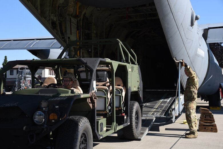 Master Sgt. Douglas Otten Jr, loadmaster for the 815th Airlift Squadron from the 403rd Wing, assists with directing Army Private First Class Carlos Castellanos, 82nd Airborne, Alpha Company rifleman, who was driving a ground mobility vehicle into the C-130J for exercise Swift Response 19, June 19, 2019. The exercise is one of the premier military crisis response training events featuring high readiness airborne forces from eight NATO nations. Activities include intermediate staging base operations, multiple airborne operations, and several air assault operations. The Swift Response exercises have had great success in creating a foundation for the strong relationships we share with several European allies and partners today. (U.S. Air Force photo by Master Sgt. Jessica Kendziorek)
