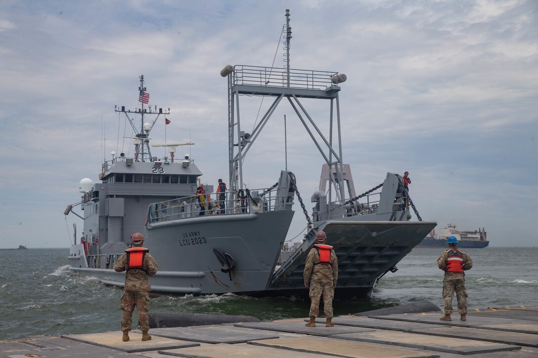 U.S. Army Soldiers with 11th Transportation Battalion, 7th Transportation Regiment prepare for a landing craft, utility to dock on a trident pier during exercise Resolute Sun at Fort Story, V.A., June 18, 2019. U.S. Marines participated in the exercise to increase combat operational readiness in amphibious and prepositioning operations while conducting joint training with the U.S. Army during a joint logistics over the shore scenario. (U.S. Marine Corps photo by Lance Cpl. Scott Jenkins)