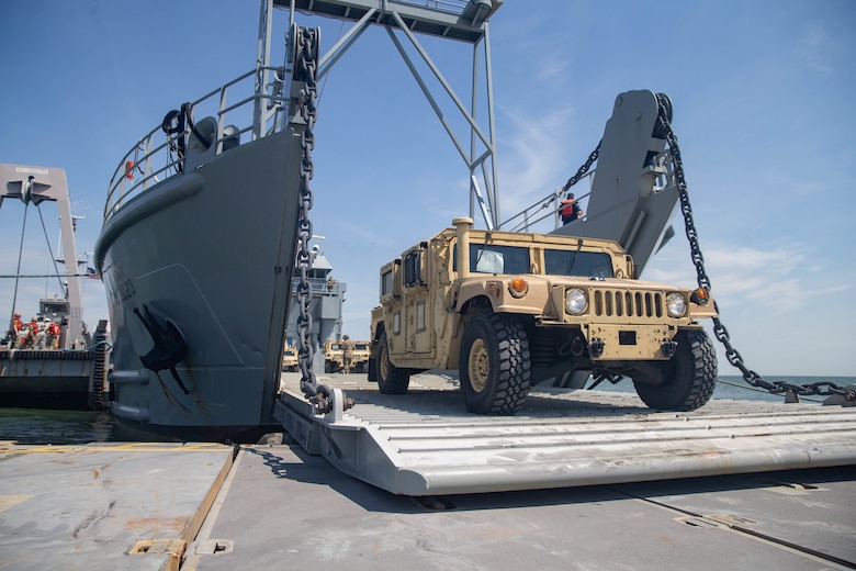 A U.S. Marine Corps Humvee from 2nd Transportation Support Battalion, Combat Logistics Regiment 2, 2nd Marine Logistics Group, drives off a landing craft, utility during exercise Resolute Sun at Fort Story, V.A., June 18, 2019. U.S. Marines participated in the exercise to increase combat operational readiness in amphibious and prepositioning operations while conducting joint training with the U.S. Army during a joint logistics over the shore scenario. (U.S. Marine Corps photo by Lance Cpl. Scott Jenkins)