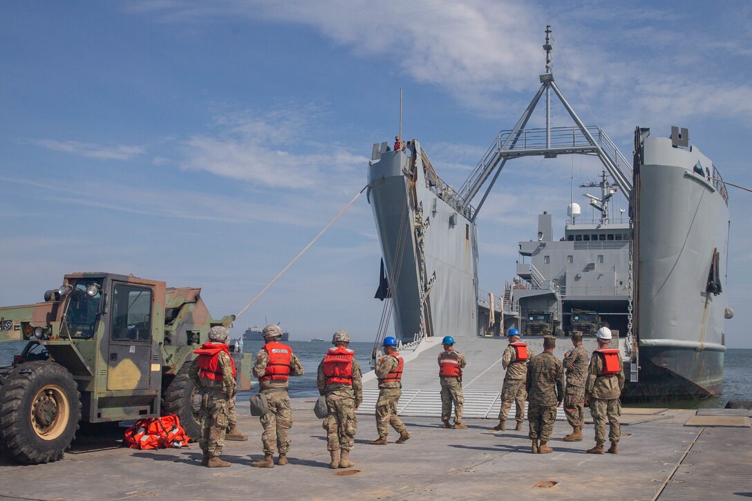 U.S. Soldiers with 11th Transportation Battalion, 7th Transportation Regiment, prepare to off load a landing craft, utility from the USNS Watkins (T-AKR-315) as part of exercise Resolute Sun at Fort Story, V.A., June 18, 2019. U.S. Marines participated in the exercise to increase combat operational readiness in amphibious and prepositioning operations while conducting joint training with the U.S. Army during a joint logistics over the shore scenario. (U.S. Marine Corps photo by Lance Cpl. Scott Jenkins)