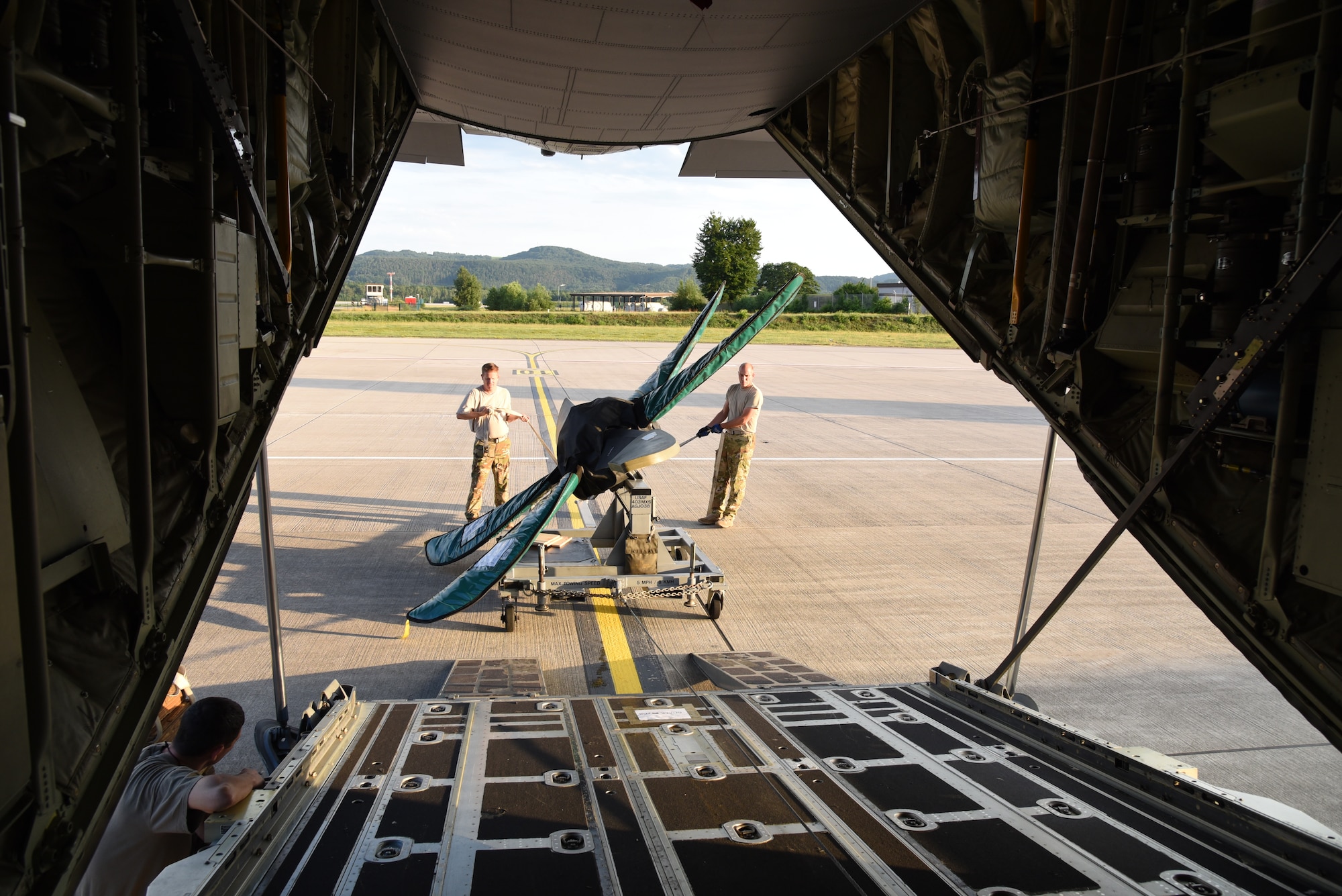 Senior Master Sgts. Eric Gassiott and John Kittrell, loadmasters for the 815th Airlift Squadron from the 403rd Wing, load a propeller onto the C-130J at the conclusion of exercise Swift Response 19, June 19, 2019. The exercise is one of the premier military crisis response training events featuring high readiness airborne forces from eight NATO nations. Activities include intermediate staging base operations, multiple airborne operations, and several air assault operations. The Swift Response exercises have had great success in creating a foundation for the strong relationships we share with several European allies and partners today. (U.S. Air Force photo by Master Sgt. Jessica Kendziorek)