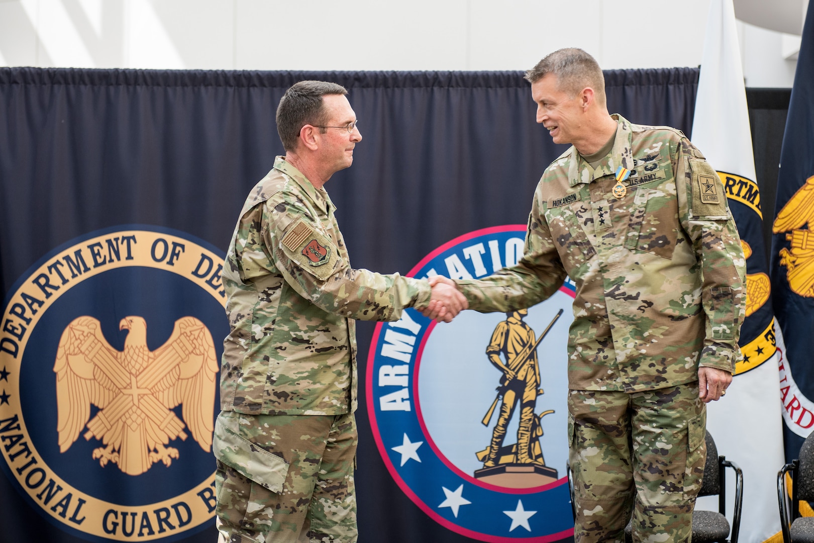 Air Force Gen. Joseph L. Lengyel, chief of the National Guard Bureau, congratulates Army Lt. Gen. Daniel Hokanson, who became of the Army National Guard in a ceremony June 21, 2019, at the Herbert R. Temple Army National Guard Readiness Center, Arlington Hall Station in Arlington, Virginia.