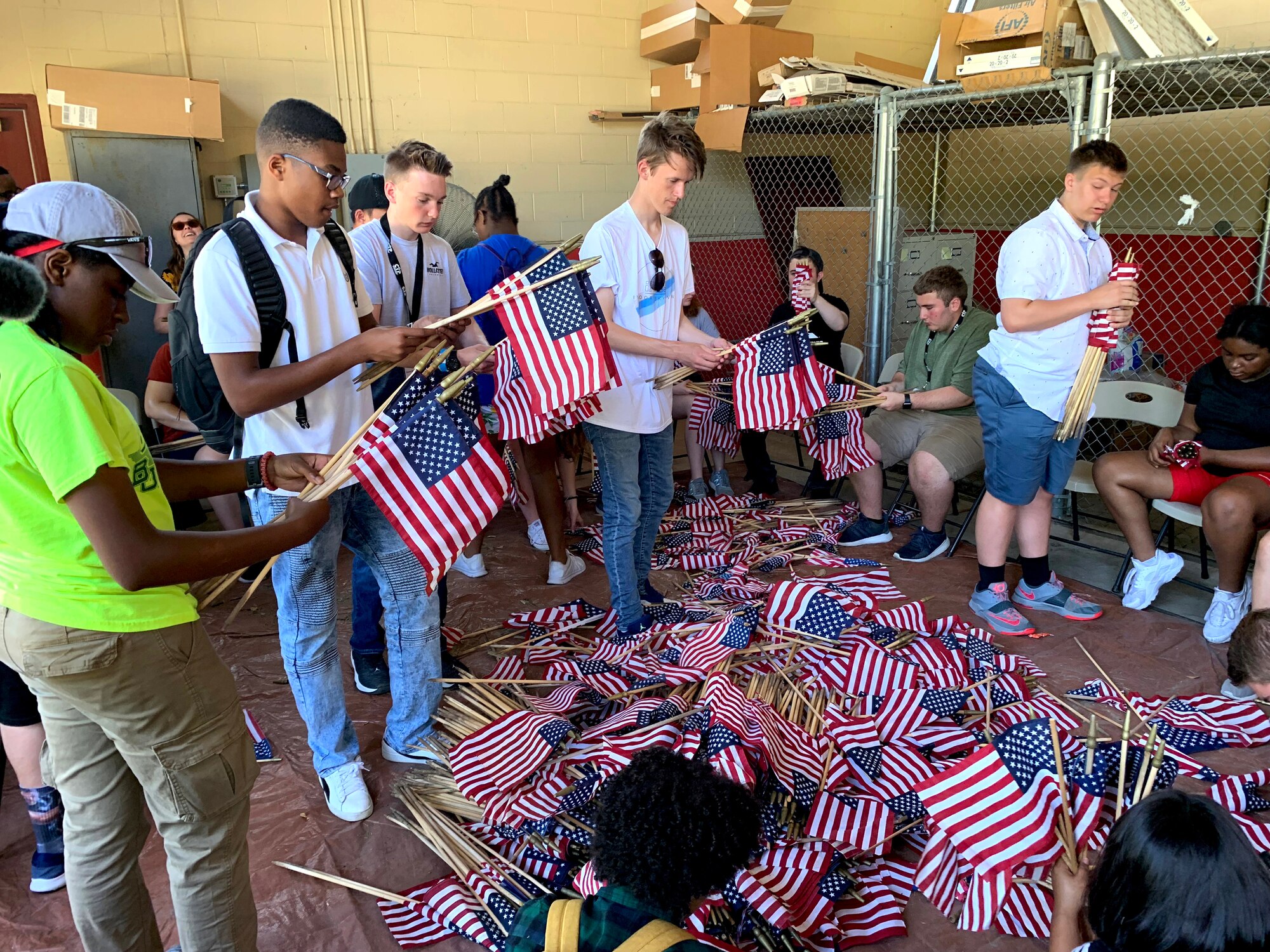 Attendees of the 2019 Youth of the Year Summit gather, roll and store American flags at the Fort Sam Houston Cemetery, San Antonio, June 19, 2019. During their week in Texas, about 60 teens from across the Air Force took part in a variety of activities focused on teambuilding, leadership, community service and personal growth. The week culminates June 20 when the Air Force Youth of the Year will be named. The winner goes on to compete for Military Youth of the Year in September. The Air Force, through the Air Force Services Center, partners with the Boys and Girls Clubs of America to offer the Youth of the Year program. (U.S. Air Force photo by Debbie Aragon)