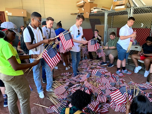 Attendees of the 2019 Youth of the Year Summit gather, roll and store American flags at the Fort Sam Houston Cemetery, San Antonio, June 19, 2019. During their week in Texas, about 60 teens from across the Air Force took part in a variety of activities focused on teambuilding, leadership, community service and personal growth. The week culminates June 20 when the Air Force Youth of the Year will be named. The winner goes on to compete for Military Youth of the Year in September. The Air Force, through the Air Force Services Center, partners with the Boys and Girls Clubs of America to offer the Youth of the Year program. (U.S. Air Force photo by Debbie Aragon)