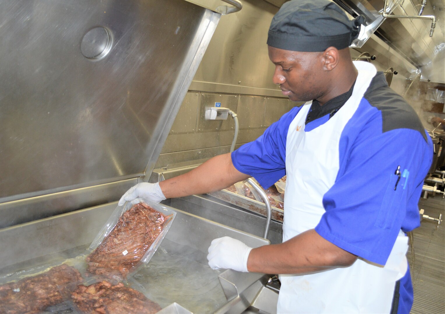 Anthony Carter, a cook at Brooke Army Medical Center’s dining facility, warms food up to the proper temperature in order to begin preparing it for lunch June 21. BAMC earned three Practice Greenhealth Environmental Awards at the CleanMed2019 conference, including its first Circle of Excellence – Chemicals Award, for its overall commitment to environmental stewardship and sustainability practices.