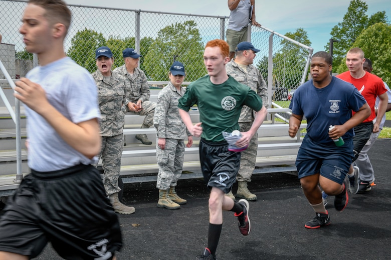 Air Force Junior Reserve Officer Training Corps cadets run toward a bus at Youngstown Air Reserve Station on June 12, 2019.