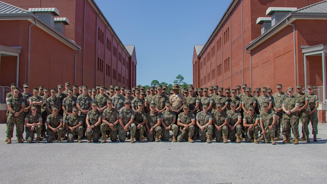 U.S. Marines with 2nd Transportation Support Battalion (2nd TSB), Combat Logistics Regiment 2 (CLR 2), 2nd Marine Logistics Group (2nd MLG), pose for a group photo with 1st Sgt. Nicholas Underwood with Company K, 3rd Recruit Training Battalion, Recruit Training at Marine Corps Recruit Depot (MCRD) Parris Island, S.C., June 14, 2019. U.S. Marines with 2nd TSB participated in a primary military education trip to MCRD Parris Island to reinforce core values and gain a different perspective on recruit training. (U.S. Marine Corps photo by Lance Cpl. Scott Jenkins)