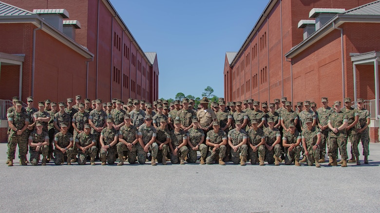 U.S. Marines with 2nd Transportation Support Battalion (2nd TSB), Combat Logistics Regiment 2 (CLR 2), 2nd Marine Logistics Group (2nd MLG), pose for a group photo with 1st Sgt. Nicholas Underwood with Company K, 3rd Recruit Training Battalion, Recruit Training at Marine Corps Recruit Depot (MCRD) Parris Island, S.C., June 14, 2019. U.S. Marines with 2nd TSB participated in a primary military education trip to MCRD Parris Island to reinforce core values and gain a different perspective on recruit training. (U.S. Marine Corps photo by Lance Cpl. Scott Jenkins)