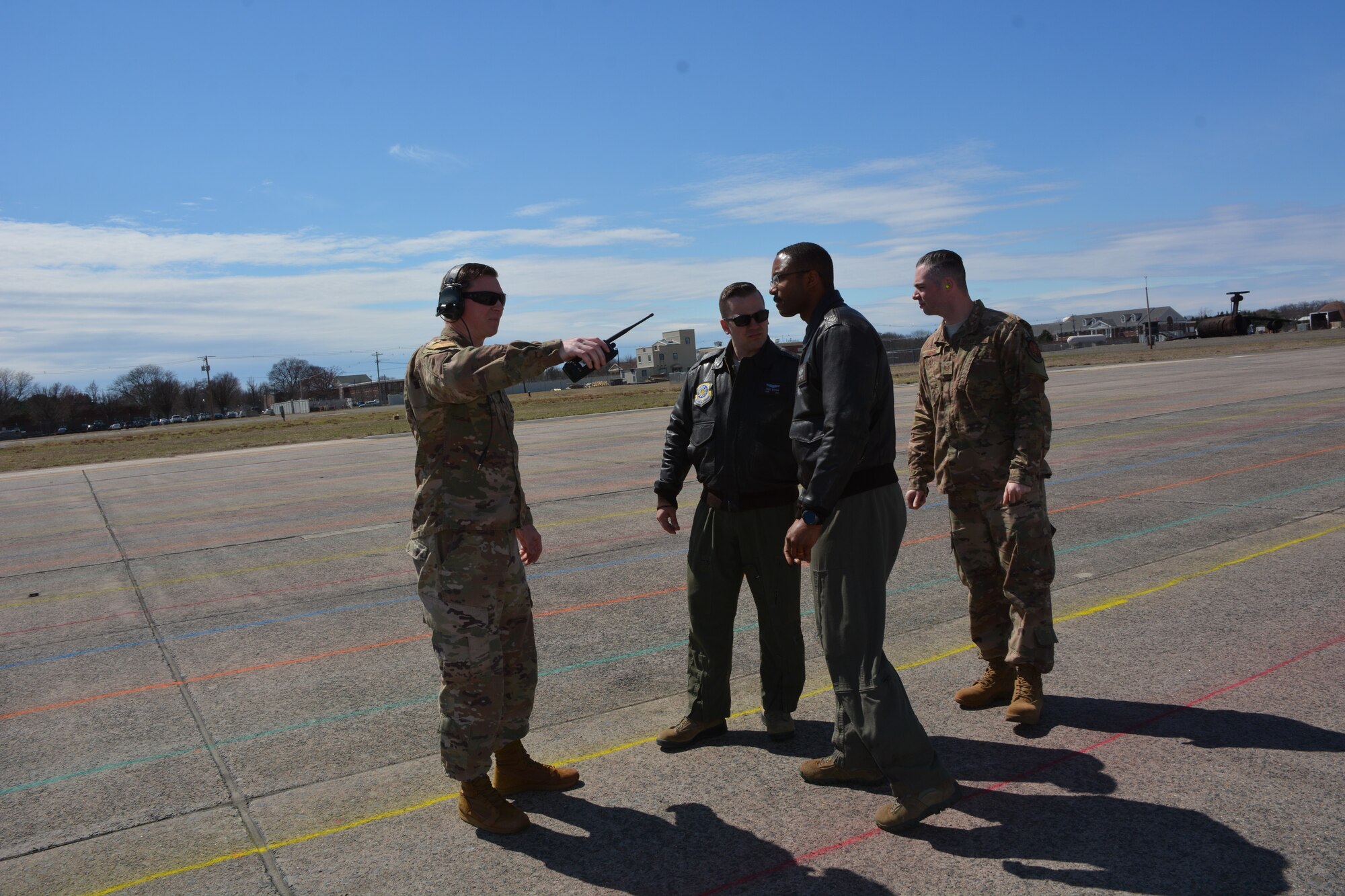 AMCTES Test Director Technical Sergeant Chris Olmsted discusses runway markings with test team members Captain Stephen Borodin, Technical Sergeant Lawrence Scott and Technical Sergeant John Newby during execution of the C-5 Heavyweight Minimum Radius 180-Degree Turn Tactics Development and Evaluation done  April 8-12, 2019 at Westover Air Reserve Base in Chicopee, MA.