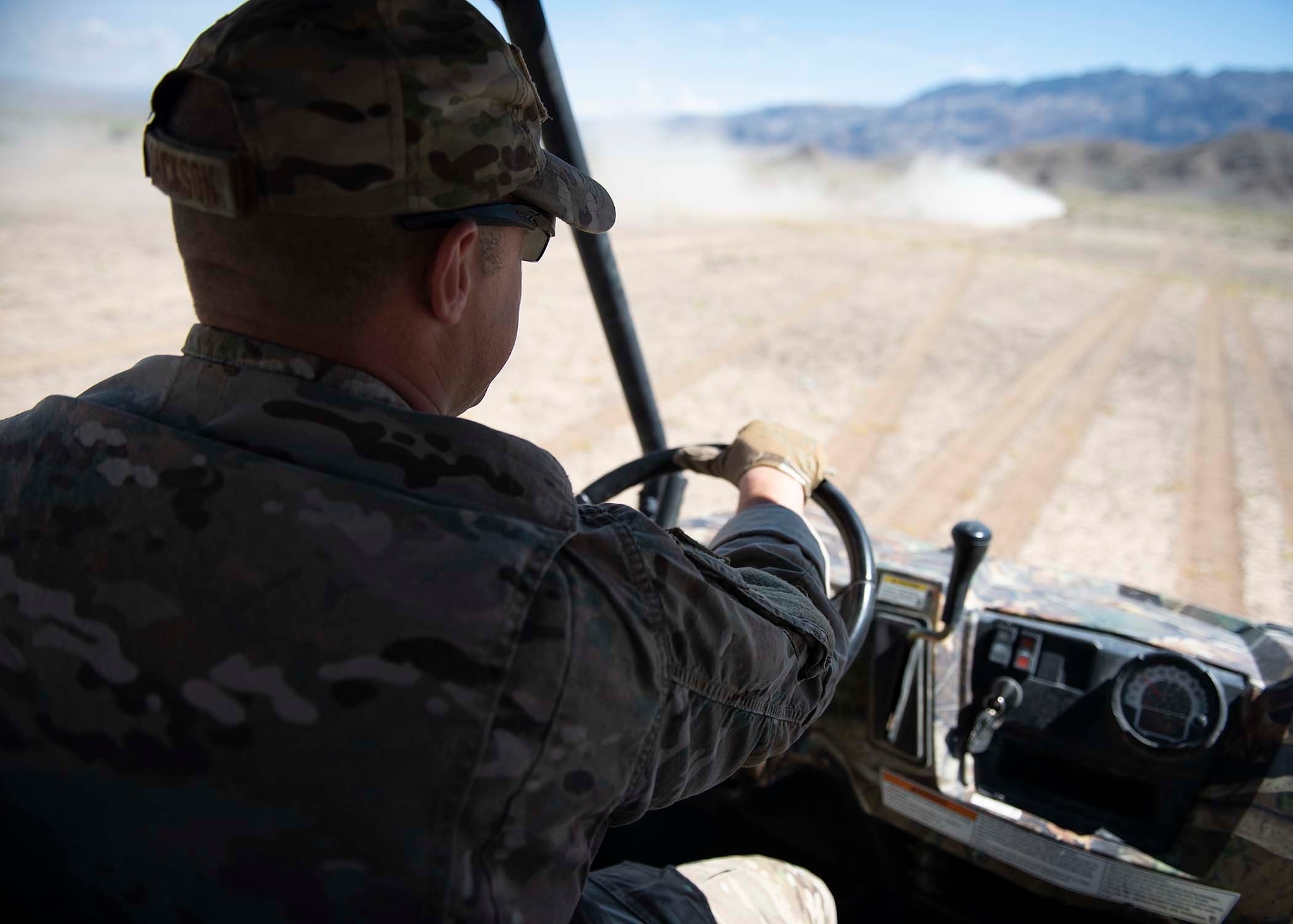 Explosive Ordnance Disposal technician drives a vehicle off road.