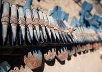 Unexploded ordnance sits lined up on the ground.