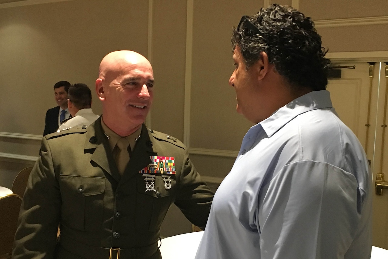 A Marine speaks with a civilian.