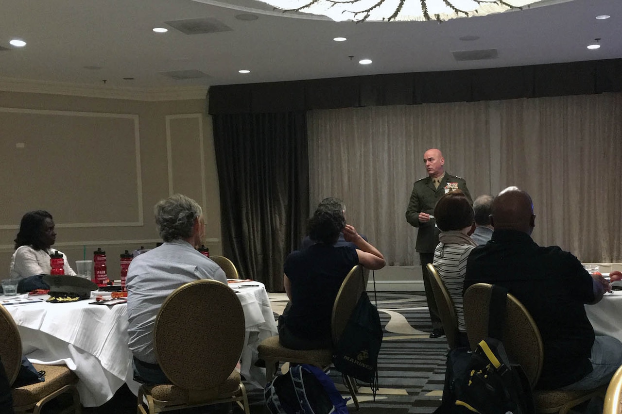 A man speaks to a group.